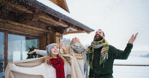 Family with small daughter having fun on terrace outdoors, holiday in winter nature. photo