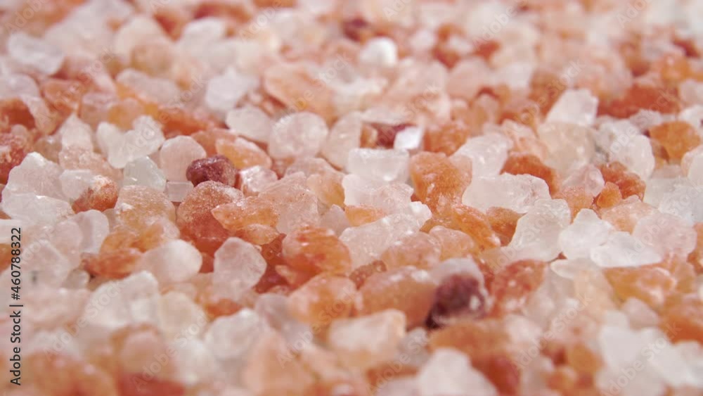 Himalayan coarse rock salt. Orange pink rough crystals. Macro. Dolly shot Himalayan coarse rock salt. Orange pink rough crystals. Macro. Dolly shot