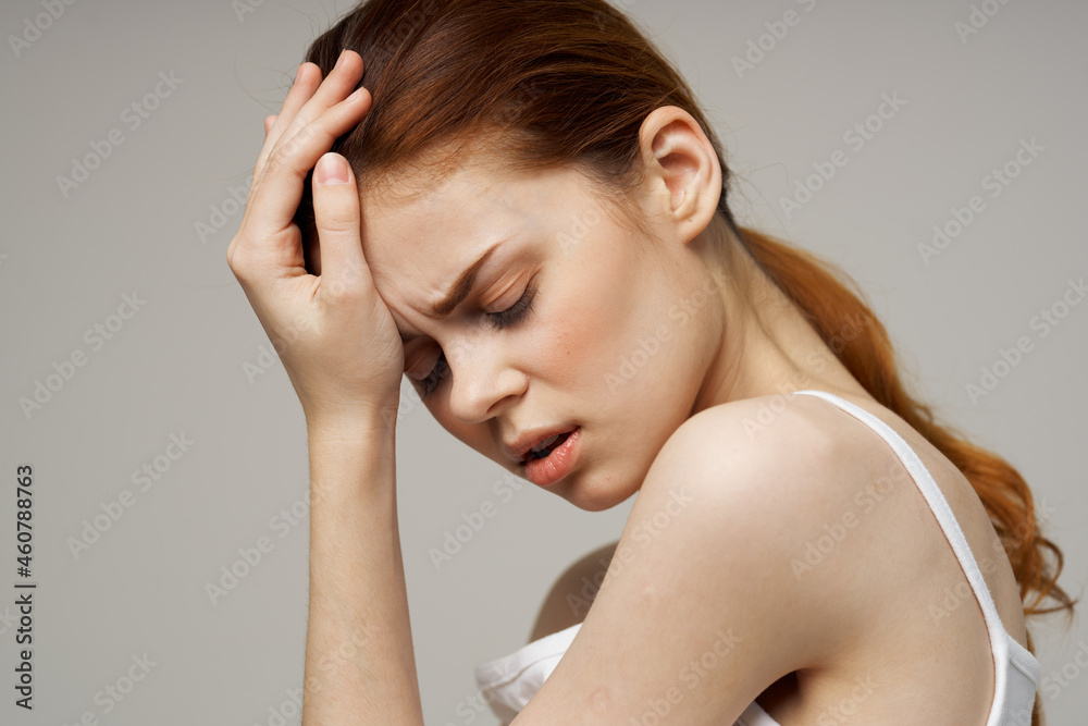 woman in white t-shirt holding head migraine disorder isolated background woman in white t-shirt holding head migraine disorder isolated background