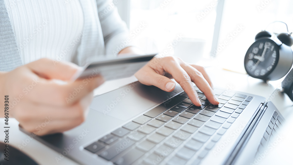 Woman hand holding credit card and using laptop. Online payment, Online shopping concept Woman hand holding credit card and using laptop. Online payment, Online shopping concept