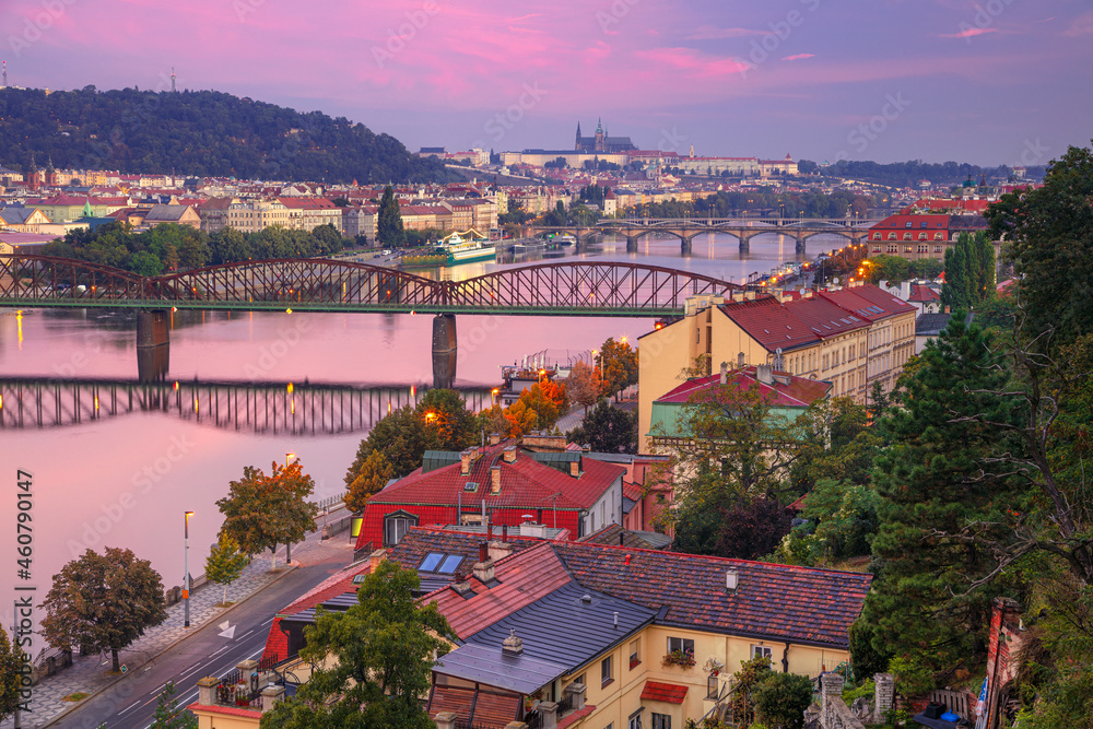 Prague at sunrise. Cityscape image of Prague, capital city of Czech Republic with St. Vitus Cathedral and five bridges over Vltava River at autumn sunrise.