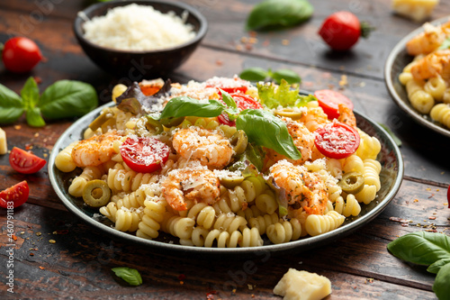 Prawn pasta salad with marinated green olives, cherry tomatoes and parmesan cheese.