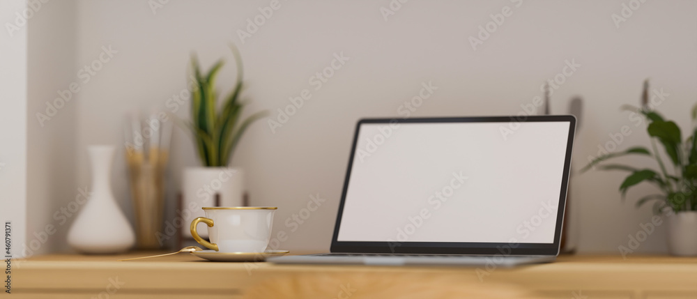 Modern portable laptop computer stand on wooden worktable with modern decorations