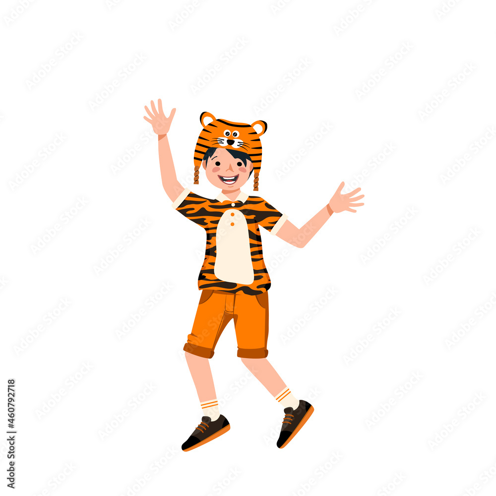 Boy in carnival costume and tiger hat. Festive clothing for theatre, new year, Christmas and holiday. Child is dancing with joyful face and happy emotions