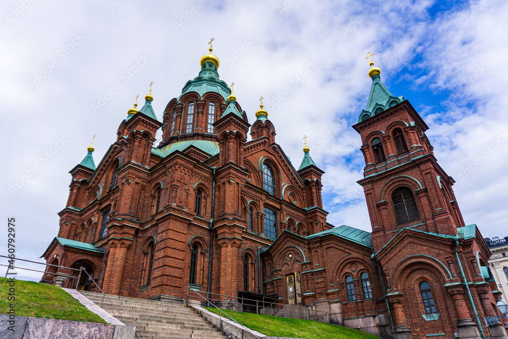 Orthodox church made of red stones in Helsinki with a cloudy background
