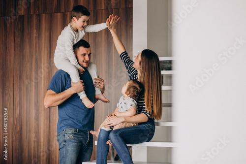 Young family with their little son at home having fun photo