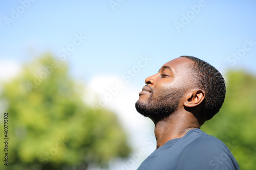 Profile of a black man breathing fresh air in nature photo