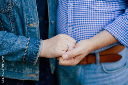 Caucasian man and woman holding hands