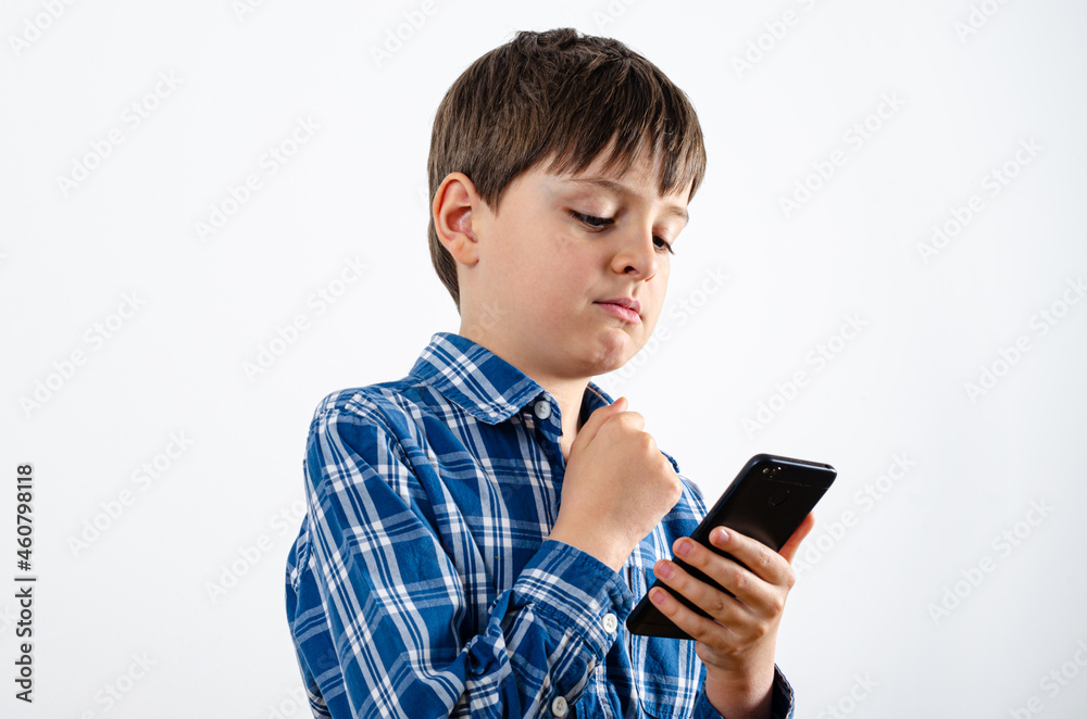 Boy is carefully looking at the phone Boy is carefully looking at the phone