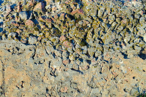 Rough old concrete texture with rubbles and moss