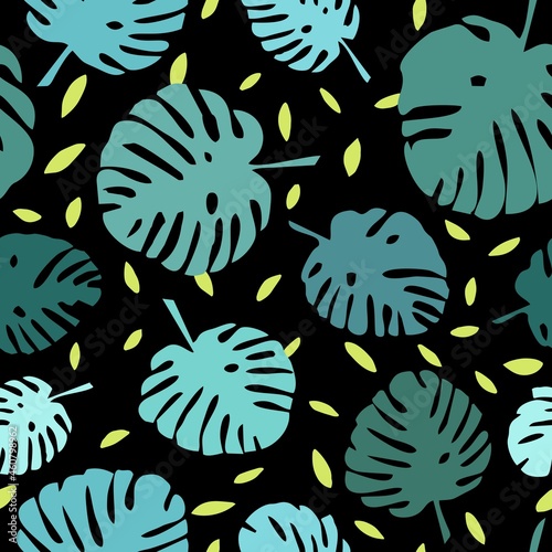 Tile tropical vector pattern with green exotic leaves on black background