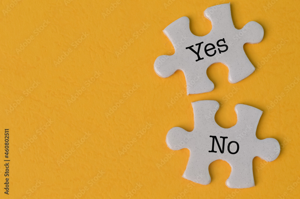 Obraz premium Jigsaw puzzle with text YES and NO isolated on a yellow background