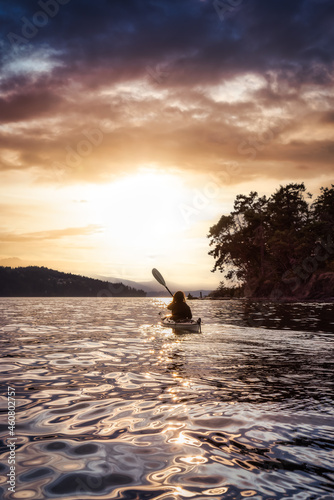 Adventurous Woman on Sea Kayak paddling in the Pacific Ocean. Dramatic Sunset Sky Art Render. Taken near Victoria, Vancouver Islands, British Columbia, Canada. Concept: Sport, Adventure © edb3_16