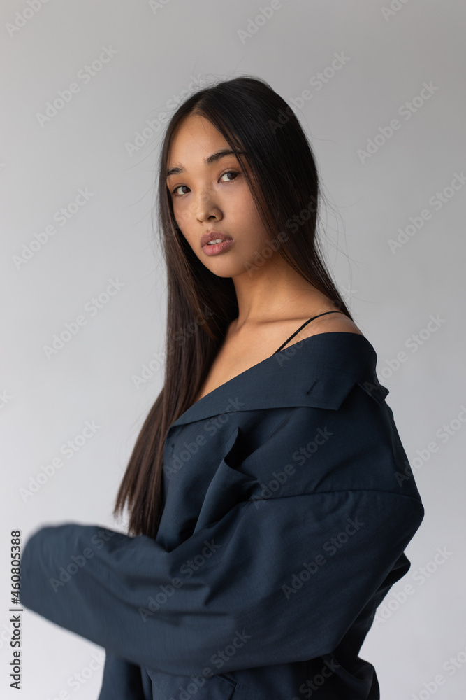Attractive asian woman in jacket posing on white background. Attractive asian woman in jacket posing on white background.