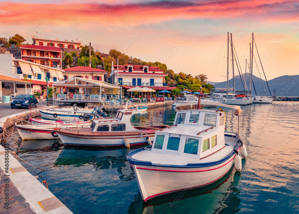 Fishing boats in Vathi port. Colorful evening scene of Peloponnese peninsula, Greece, Europe. Beautiful Ioninan seascape. Traveling concept background.