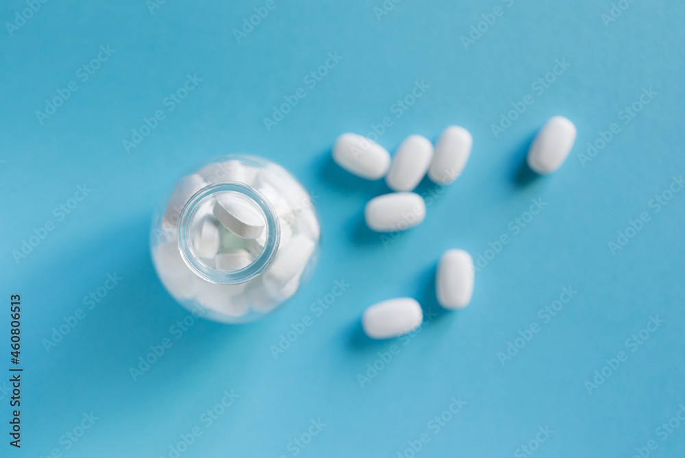 White pills on blue background White pills on blue background