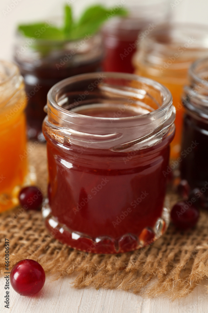 Jar of sweet jam on table, closeup Jar of sweet jam on table, closeup