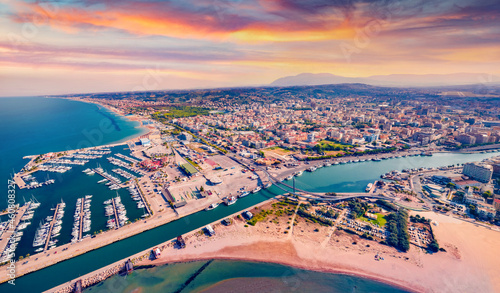 Spectacular summer view from flying drone Pescara port. Attractive sunset on Adriatic sea. Breathtaking evening scene of Italy, Europe.