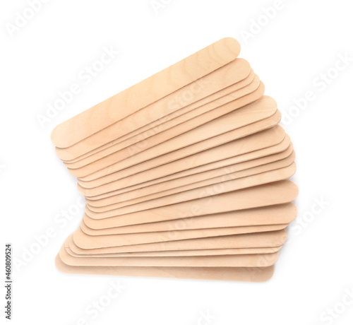 Disposable wooden spatulas for depilatory wax on white background, top view