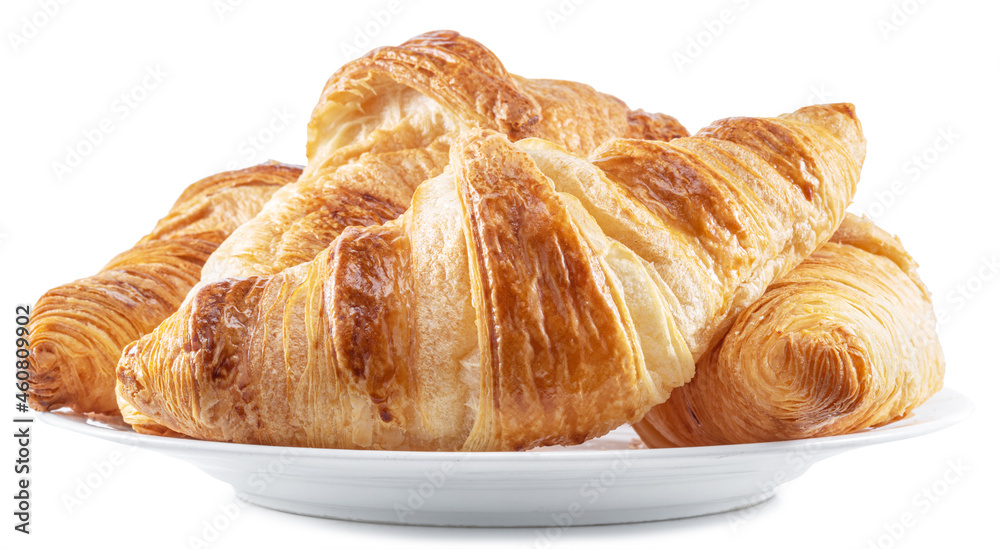 Tasty crusty croissants on the plate on white background. File contains clipping path.