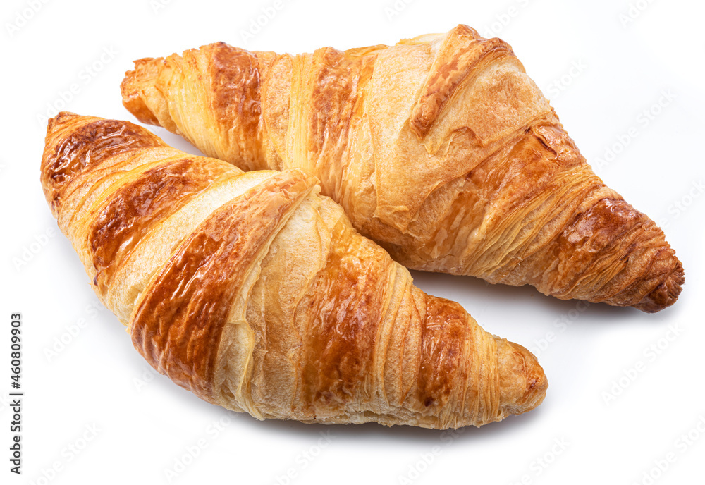 Tasty crusty croissants close-up on a white background.