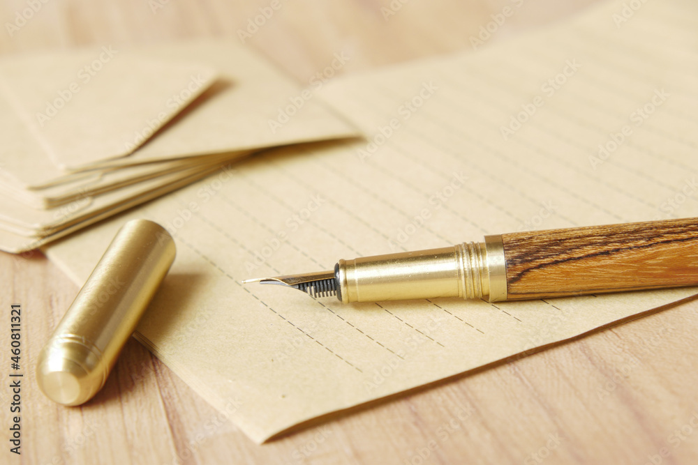 envelope , empty paper and fountain pen on table envelope , empty paper and fountain pen on table