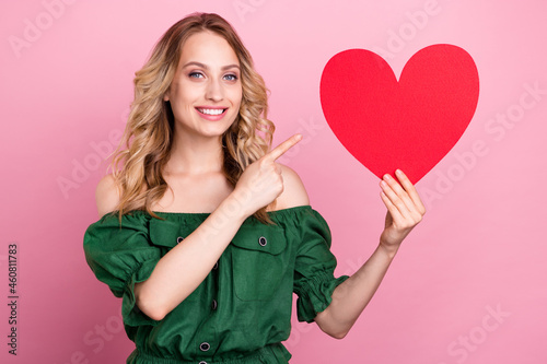 Photo of promoter lady direct finger red heart love tips wear bear shoulders green blouse isolated pink color background