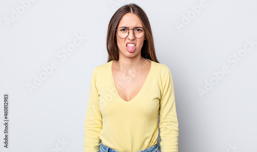 Canvas Print hispanic pretty woman feeling disgusted and irritated, sticking tongue out, disl