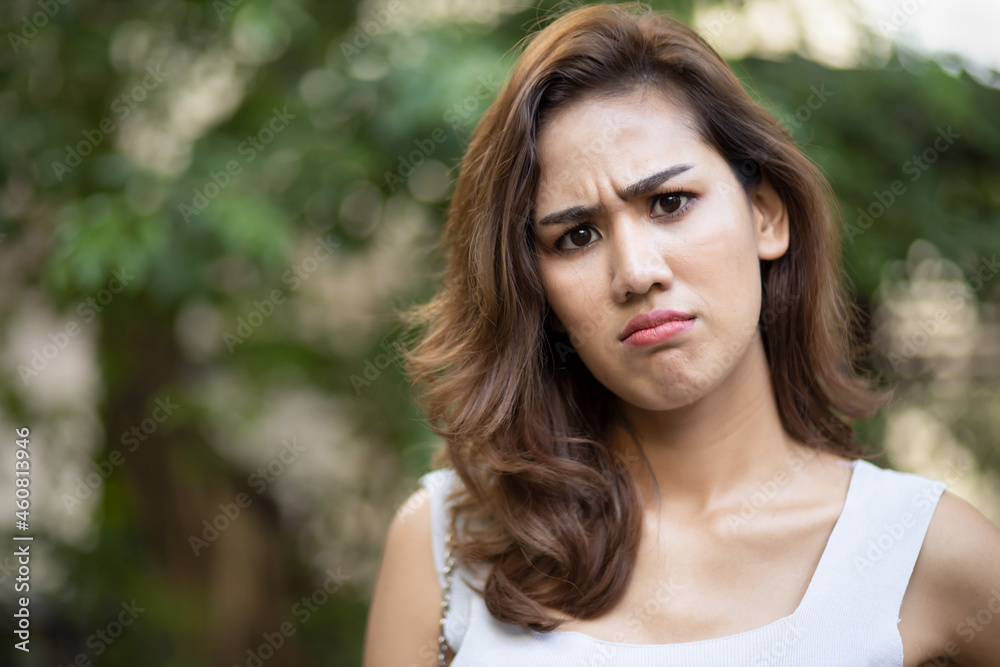 Frowning woman giving rejecting thumb down gesture Frowning woman giving rejecting thumb down gesture