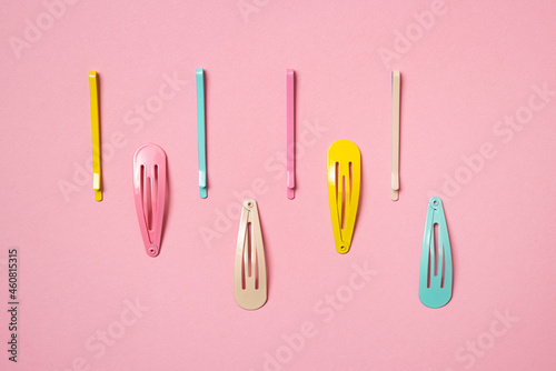 Colorful pastel accessories hairpin on pink background, close up, trendy modern from past photo