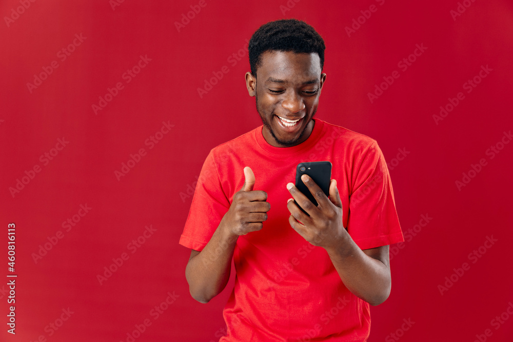 Cheerful man of african appearance with mobile phone laughing Cheerful man of african appearance with mobile phone laughing