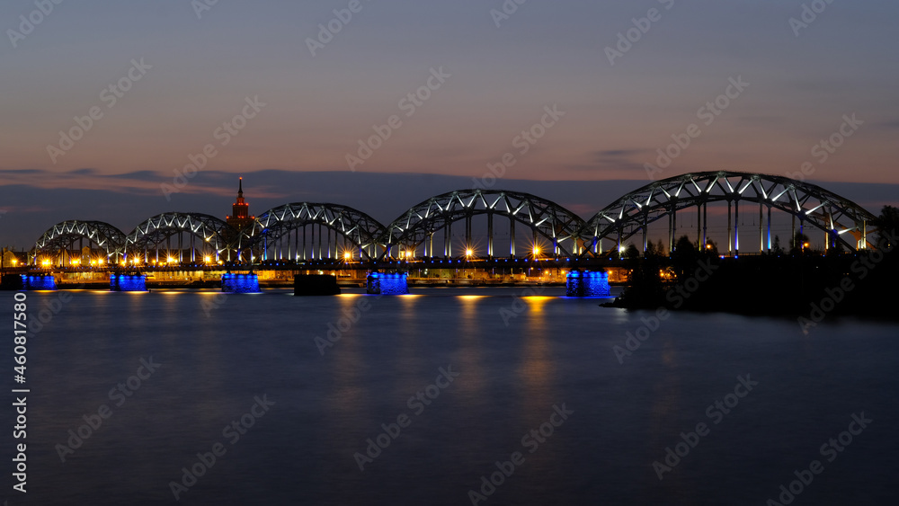 Dawn in Riga over the Daugava river against the background of the railway bridge