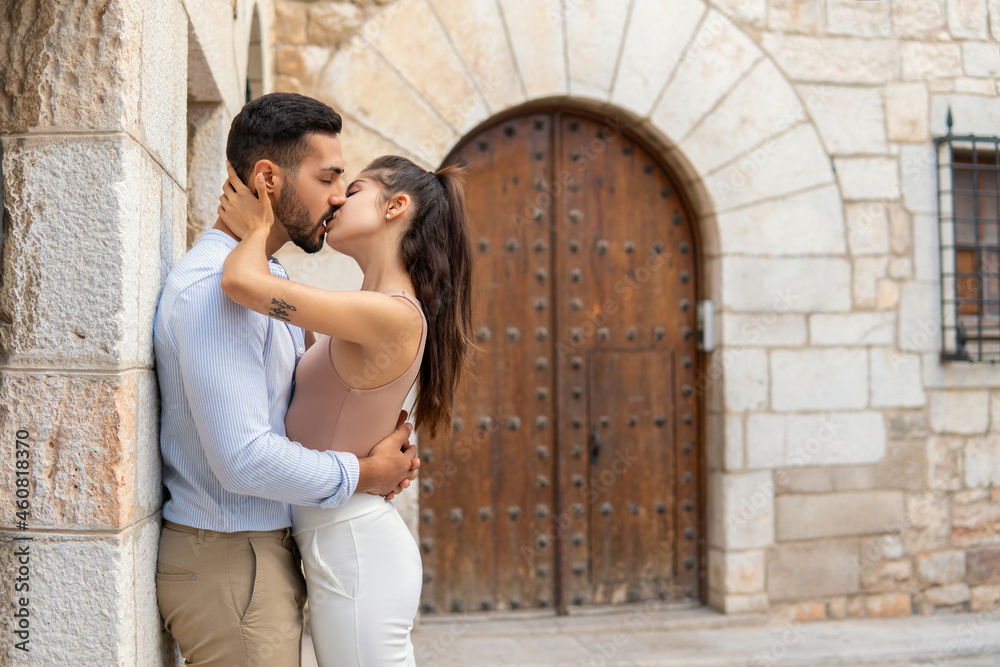 Hispanic couple kissing in city