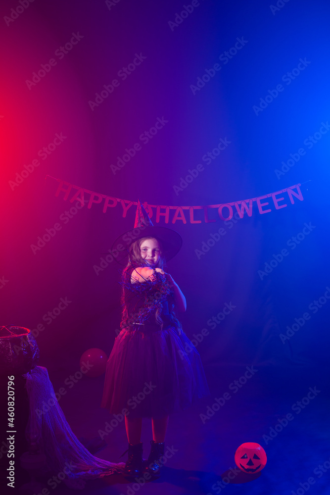 Little girl holds broom on Halloween holiday. Kid girl wear witch costume. Fantasy, fairy tale and masquerade concept. Little girl holds broom on Halloween holiday. Kid girl wear witch costume. Fantasy, fairy tale and masquerade concept.