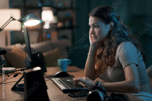 Young woman working from home at night