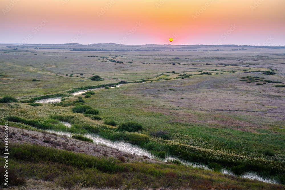Morning summer landscape with sunrise over the valley of the steppe river. Bolshaya Karaganka river near Arkaim village, Russia