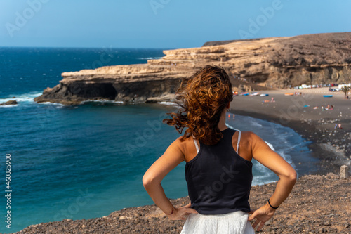 A young girl on vacation on the beach of Ajuy, Pajara, west coast of the island of Fuerteventura, Canary Islands. Spain