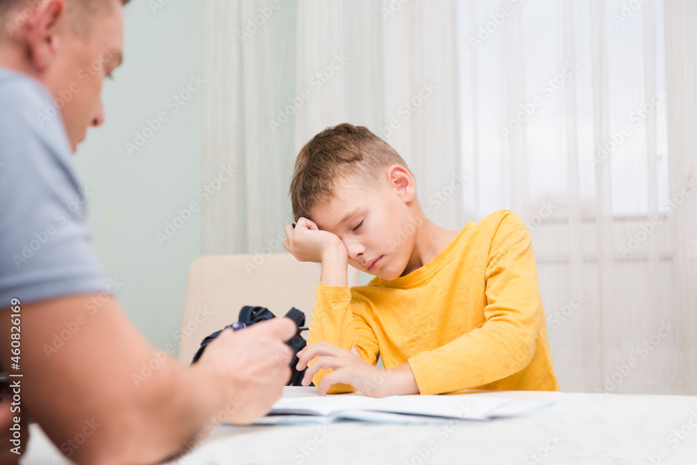 tired schoolboy do lessons at home. homeschooling, distant learning. dad helps son study
tired schoolboy do lessons at home. homeschooling, distant learning. dad helps son study