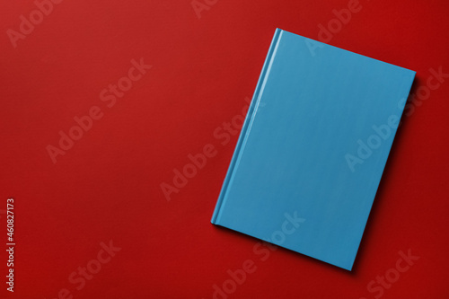 Bild auf Leinwand New stylish planner with hard cover on red background, top view