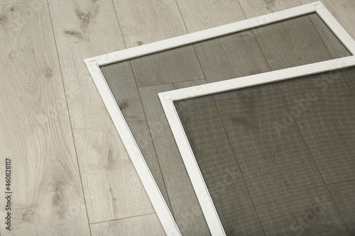 New insect screens for windows on wooden floor