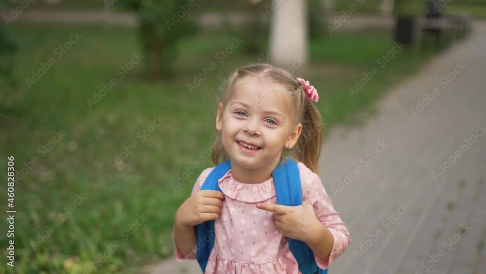 Schoolgirl girl goes to school. New normal. Schoolgirl walks with backpack in park. Back to school. Social distance in park. Schoolgirl with backpack goes to class. Preschool girl. Educational school Schoolgirl girl goes to school. New normal. Schoolgirl walks with backpack in park. Back to school. Social distance in park. Schoolgirl with backpack goes to class. Preschool girl. Educational school
