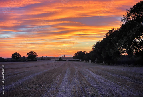 fiery sunset over a stubble field