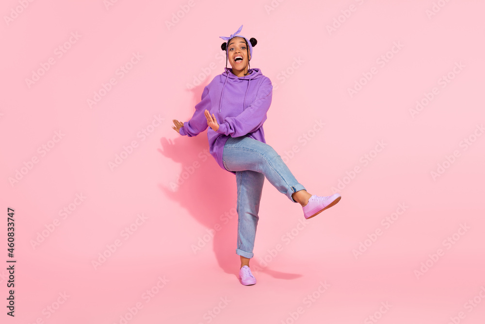 Photo of sweet attractive afro woman wear purple hoodie buns dancing smiling isolated pink color background
