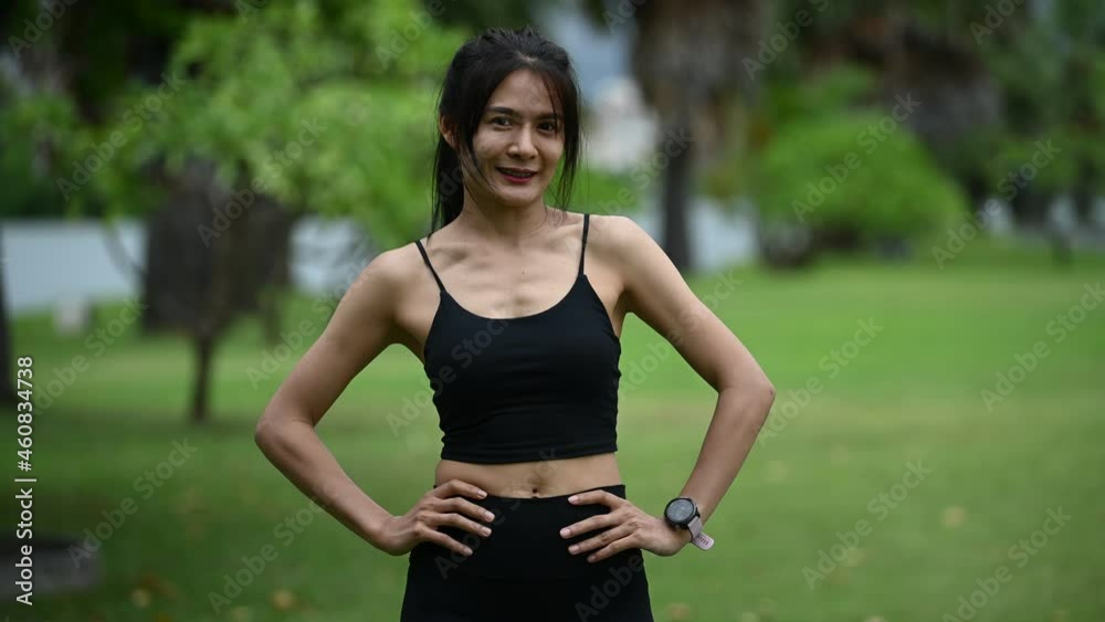 Asian sporty woman stretching body breathing fresh air in the park,Thailand people,Fitness and exercise concept Asian sporty woman stretching body breathing fresh air in the park,Thailand people,Fitness and exercise concept