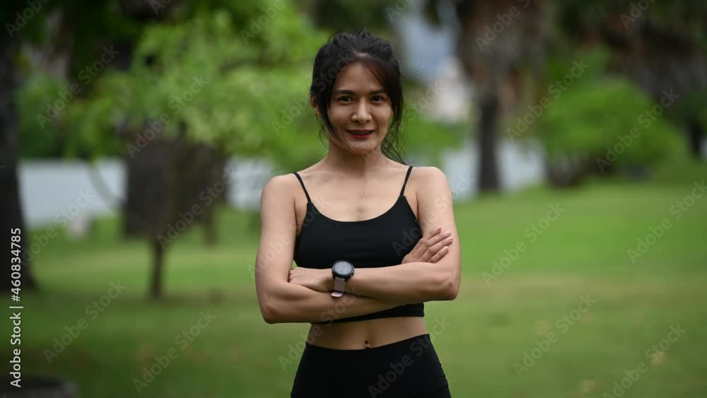 Asian sporty woman stretching body breathing fresh air in the park,Thailand people,Fitness and exercise concept Asian sporty woman stretching body breathing fresh air in the park,Thailand people,Fitness and exercise concept