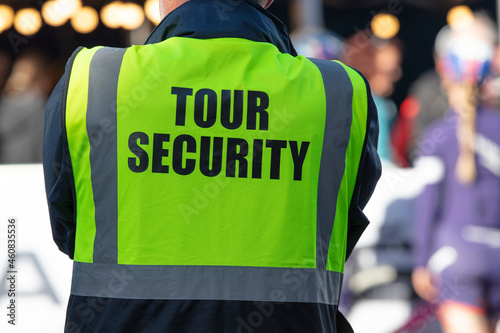 A security guard officer at a public event with tour security on a jacket