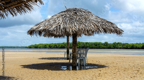 Croa do Gor   in Aracaju  Sergipe  Brazil. Straw parasol with shade on the sand. tourist place