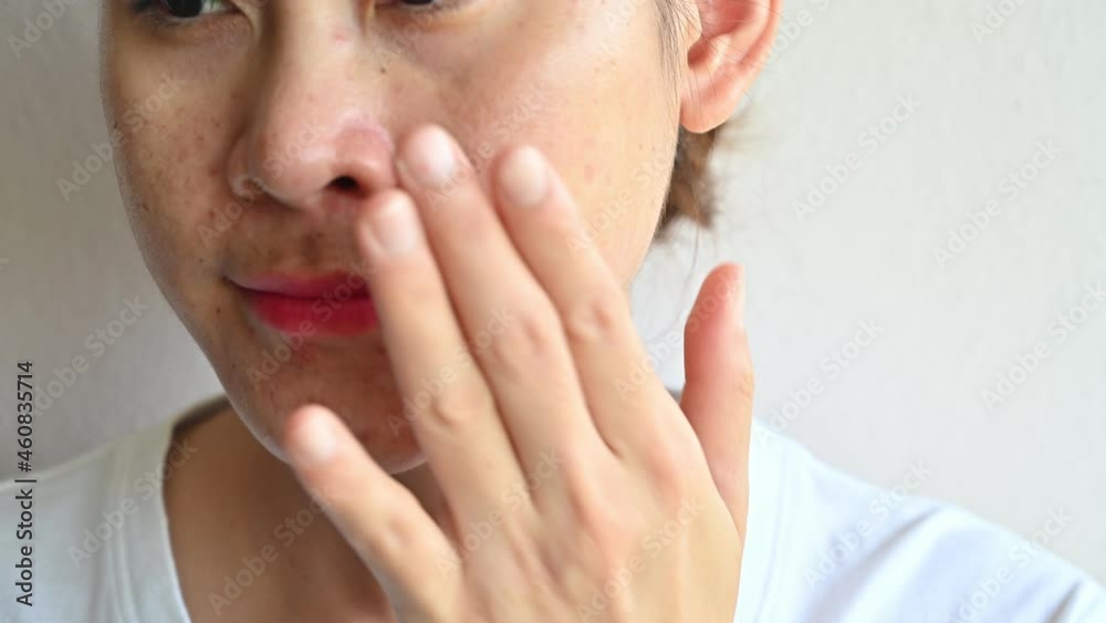 Asian woman applying moisturizer cream for treat and improve her aging skin. Moisturizing everyday can reduce the chance of developing extreme dryness or oiliness. Asian woman applying moisturizer cream for treat and improve her aging skin. Moisturizing everyday can reduce the chance of developing extreme dryness or oiliness.