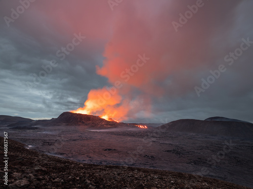 Night volcanic eruption. Fresh hot lava and poisonous gases going out from the crater.