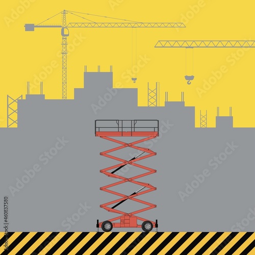 Scissors lifting platform. Construction machinery on the background of a building under construction.